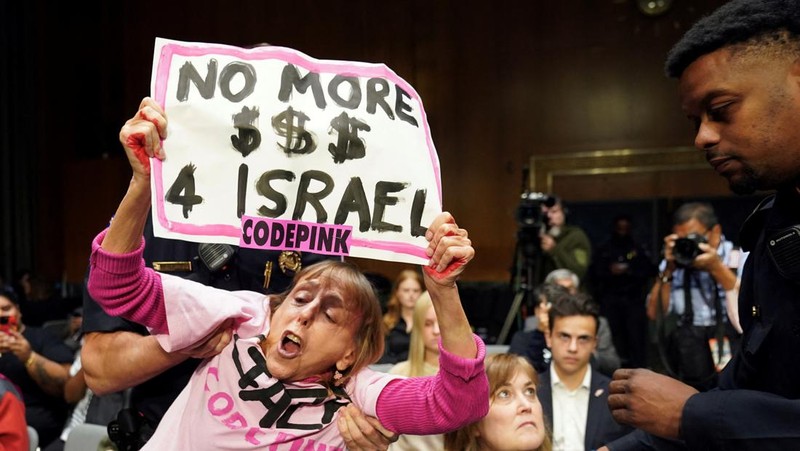 Anti-war protesters raise their  “bloody” hands behind U.S. Secretary of State Antony Blinken during a Senate Appropriations Committee hearing on President Biden's $106 billion national security supplemental funding request to support Israel and Ukraine, as well as bolster border security, on Capitol Hill in Washington, U.S., October 31, 2023. REUTERS/Kevin Lamarque