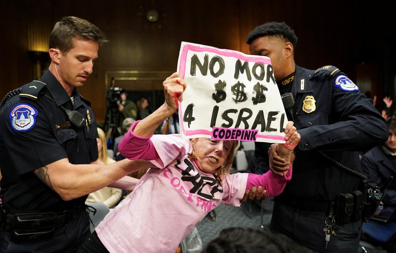 USA-CONGRESS/FUNDING Anti-war protesters raise their “bloody” hands behind U.S. Secretary of State Antony Blinken during a Senate Appropriations Committee hearing on President Biden's $106 billion national security supplemental funding request to support Israel and Ukraine, as well as bolster border security, on Capitol Hill in Washington, U.S., October 31, 2023. REUTERS/Kevin Lamarque
