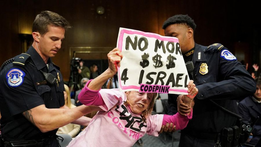 Anti-war protesters raise their  “bloody” hands behind U.S. Secretary of State Antony Blinken during a Senate Appropriations Committee hearing on President Biden's $106 billion national security supplemental funding request to support Israel and Ukraine, as well as bolster border security, on Capitol Hill in Washington, U.S., October 31, 2023. REUTERS/Kevin Lamarque