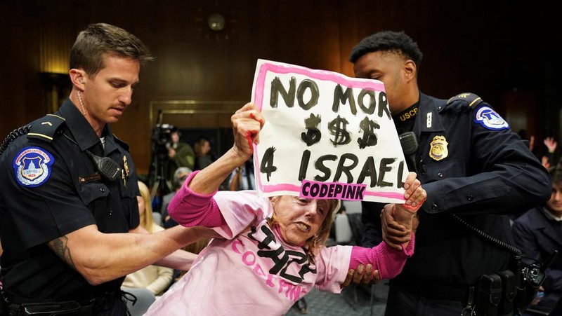 Anti-war protesters raise their  “bloody” hands behind U.S. Secretary of State Antony Blinken during a Senate Appropriations Committee hearing on President Biden's $106 billion national security supplemental funding request to support Israel and Ukraine, as well as bolster border security, on Capitol Hill in Washington, U.S., October 31, 2023. REUTERS/Kevin Lamarque