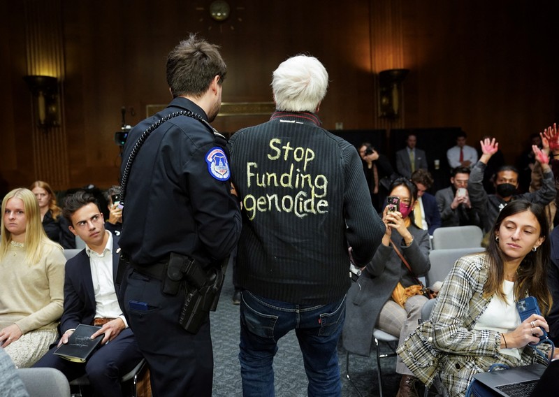 USA-CONGRESS/FUNDING Anti-war protesters raise their “bloody” hands behind U.S. Secretary of State Antony Blinken during a Senate Appropriations Committee hearing on President Biden's $106 billion national security supplemental funding request to support Israel and Ukraine, as well as bolster border security, on Capitol Hill in Washington, U.S., October 31, 2023. REUTERS/Kevin Lamarque
