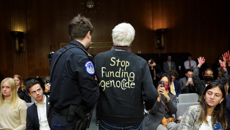 Anti-war protesters raise their  “bloody” hands behind U.S. Secretary of State Antony Blinken during a Senate Appropriations Committee hearing on President Biden's $106 billion national security supplemental funding request to support Israel and Ukraine, as well as bolster border security, on Capitol Hill in Washington, U.S., October 31, 2023. REUTERS/Kevin Lamarque