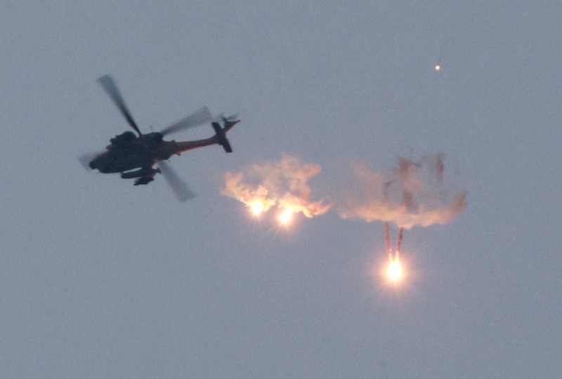 ISRAEL-PALESTINIANS/GAZA BORDER An Apache helicopter fires, amid the ongoing conflict between Israel and Palestinian Islamist group Hamas, as seen from Sderot in southern Israel, November 1, 2023. REUTERS/Ammar Awad