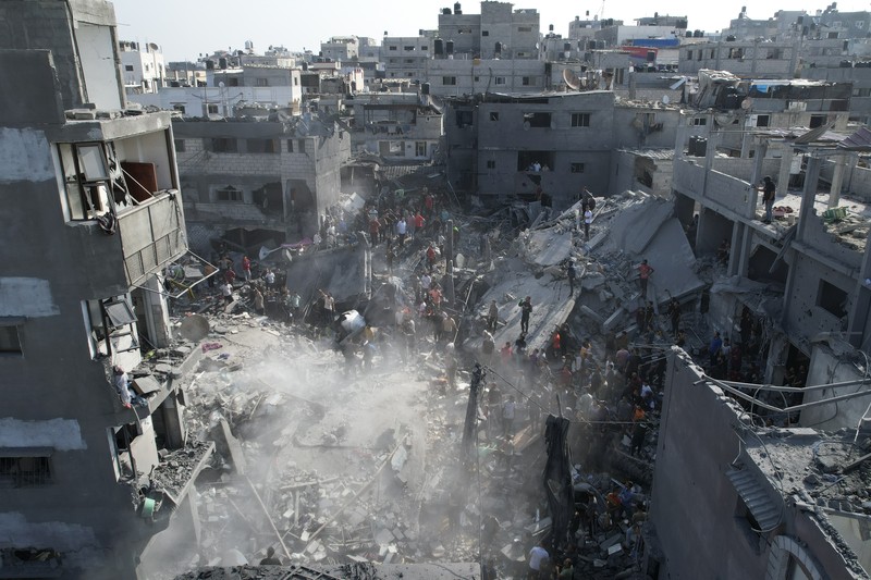 Israel Palestinians Palestinians look for survivors of the Israeli bombardment in the Maghazi refugee camp in the Gaza Strip on Sunday, Nov. 5, 2023. (AP Photo/Hatem Moussa)