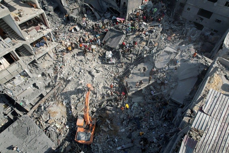 Israel Palestinians Palestinians look for survivors of the Israeli bombardment in the Maghazi refugee camp in the Gaza Strip on Sunday, Nov. 5, 2023. (AP Photo/Hatem Moussa)