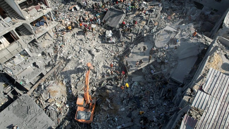 Palestinians look for survivors of the Israeli bombardment in the Maghazi refugee camp in the Gaza Strip on Sunday, Nov. 5, 2023. (AP Photo/Hatem Moussa)