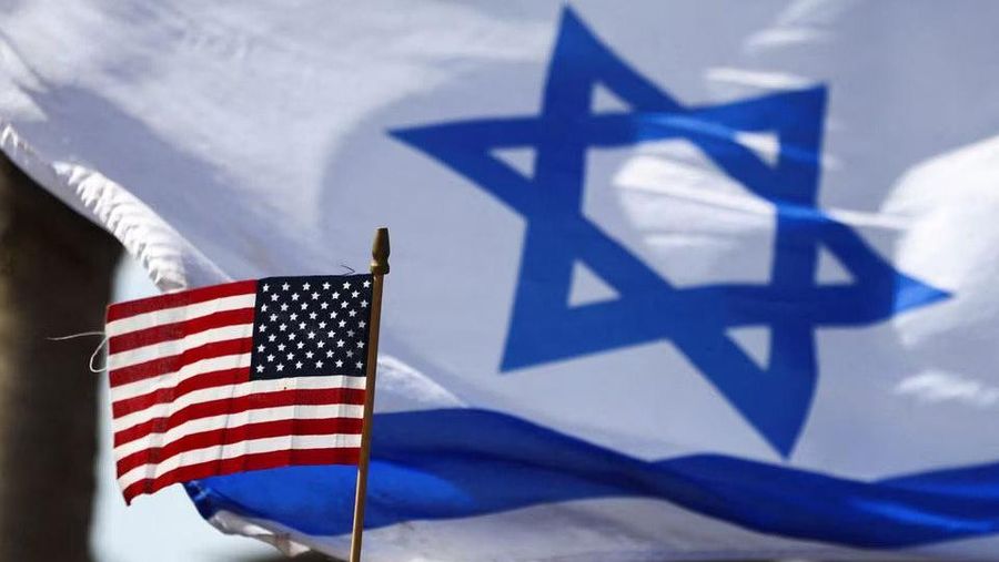 A view of a U.S. flag and an Israeli flag held up by people during a demonstration to show support for U.S. President Joe Biden, for not inviting Israeli Prime Minister Benjamin Netanyahu to the White House, in front of the U.S. Consulate in Tel Aviv, Israel, March 30, 2023. REUTERS/Ronen Zvulun/File Photo Acquire Licensing Rights