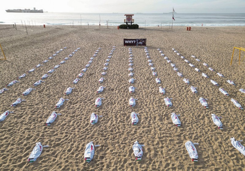 Seratus dua puluh kain kafan yang dipasang oleh anggota LSM Rio da Paz, di pantai untuk menghormati anak-anak Palestina yang terbunuh dalam konflik Israel-Hamas Gaza yang sedang berlangsung, selama demonstrasi pro-Palestina di Rio de Janeiro, Brasil, 3 November 2023. Seratus dua puluh kain kafan yang dipasang oleh anggota LSM Rio da Paz, di pantai untuk menghormati anak-anak Palestina yang terbunuh dalam konflik Israel-Hamas Gaza yang sedang berlangsung, selama demonstrasi pro-Palestina di Rio de Janeiro, Brasil, 3 November 2023. (REUTERS/Ian Cheibub)