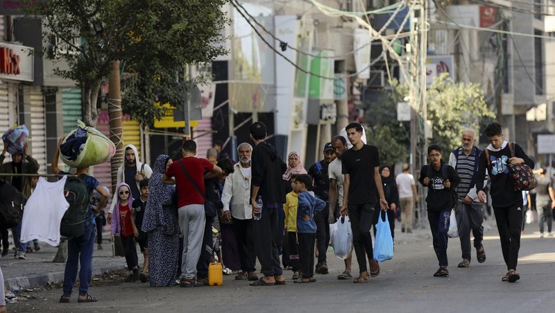 Sejumlah warga Palestina berbondong-bondong jalan sambil mengibarkan bendera putih saat mereka mengikuti perintah Israel untuk evakuasi dari Gaza utara ke selatan. (AP Photo/Abed Khaled)