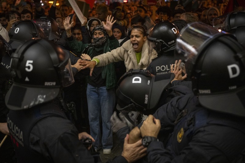 Spain Israel Palestinians Demonstrators use the flashlights on their mobile phones as they protest against Israeli attacks on Gaza, in Barcelona, Spain, Saturday, Nov. 11, 2023. (AP Photo/Emilio Morenatti)