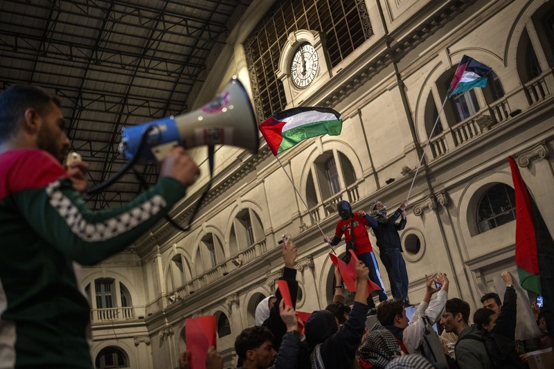 Spain Israel Palestinians Demonstrators use the flashlights on their mobile phones as they protest against Israeli attacks on Gaza, in Barcelona, Spain, Saturday, Nov. 11, 2023. (AP Photo/Emilio Morenatti)