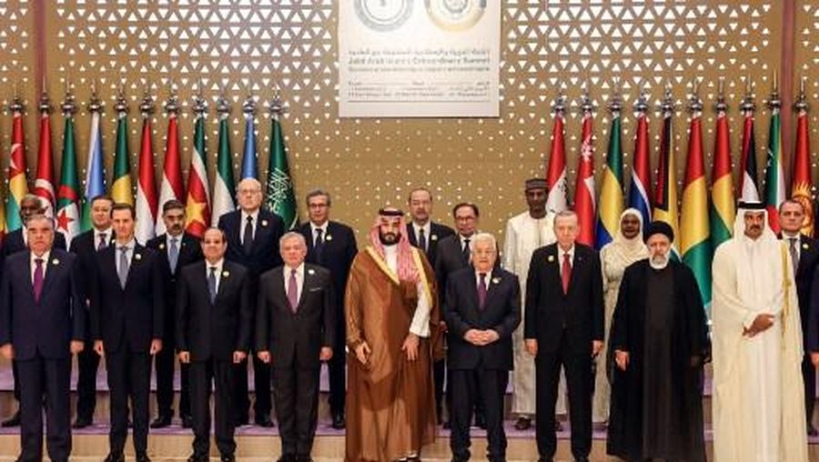 This handout picture provided by the Palestinian Press Office (PPO) on November 11, 2023, shows front row from 2nd left: Syria's President Bashar al-Assad, Egypt's President Abdel Fatah al-Sisi, Jordan's King Abdullah II, Saudi Crown Prince Mohammed bin Salman, Palestinain president Mahmud Abbas, Turkish President Recep Tayyip Erdogan, Iran's President Ebrahim Raisi and Qatar's Emir Sheikh Tamim bin Hamad al-Thani, standing for a group picture ahead of an emergency meeting of the Arab League and the Organisation of Islamic Cooperation (OIC), in Riyadh. Arab leaders and Iran's president are in the Saudi capital on November 11, for a summit meeting expected to underscore demands that Israel's war in Gaza end before the violence draws in other countries. The emergency meeting of the Arab League and the Organisation of Islamic Cooperation (OIC) comes after Hamas militants' bloody October 7 attacks that Israeli officials say left about 1,200 people dead and 239 taken hostage. (Photo by Thaer GHANAIM / PPO / AFP) / RESTRICTED TO EDITORIAL USE - MANDATORY CREDIT 