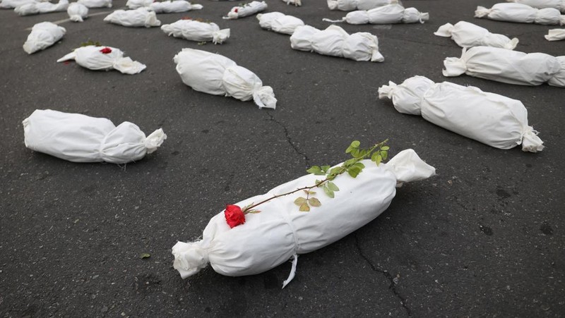 Kafan simbolis mayat anak-anak Gaza terlihat saat memberi isyarat di sebuah jalan di Teheran, Iran 13 November 2023. (Majid Asgaripour/WANA (West Asia News Agency) via REUTERS)