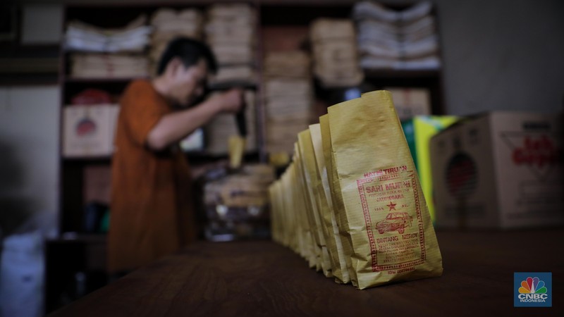 Pekerja mengemas kopi usai melalui proses penggilingan di Toko Kopi Sari Murni, Jakarta, Senin (20/11/2023). (CNBC Indonesia/Faisal Rahman)