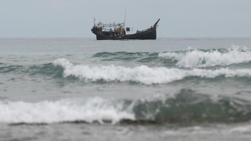 A wooden boat that carried Rohingya Muslims is seen off the coast in Sabang, Aceh province, Indonesia, November 22, 2023. REUTERS/Riska Munawarah