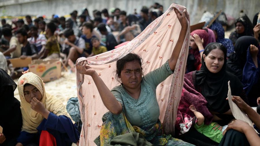 Rohingya Muslim women rest after landing on a beach in Sabang, Aceh province, Indonesia, November 22, 2023. REUTERS/Riska Munawarah. REFILE - QUALITY REPEAT