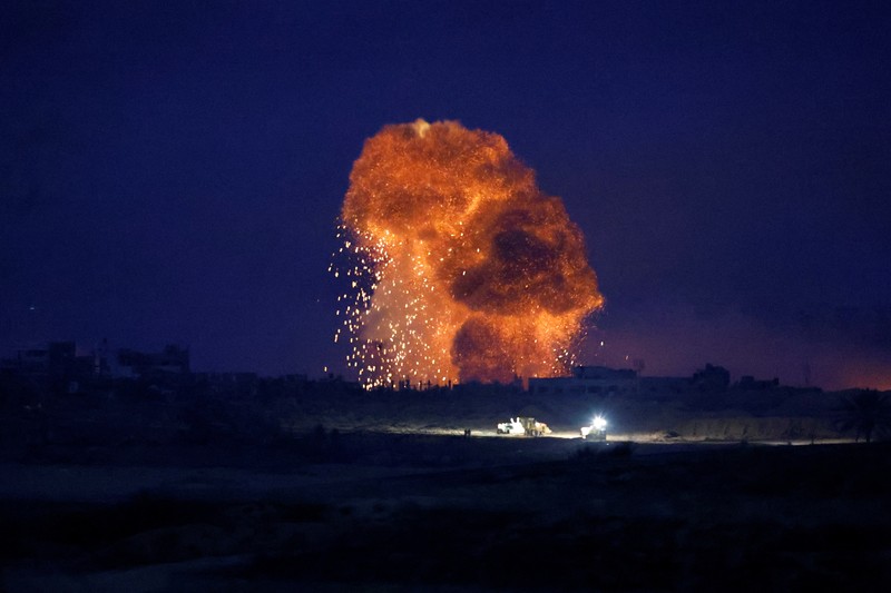An explosion takes place during Israeli air strikes over Gaza, as seen from southern Israel, amid the ongoing conflict between Israel and the Palestinian group Hamas, November 22, 2023. REUTERS/Alexander Ermochenko