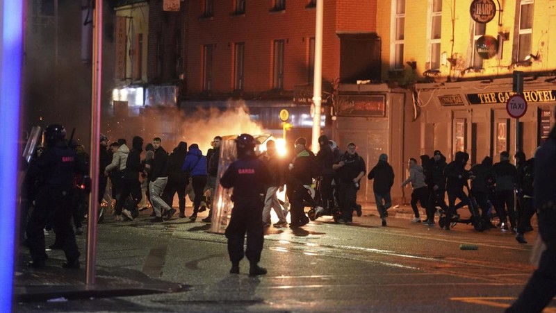 Sebuah bus dan mobil terbakar setelah adegan kekerasan terjadi di pusat kota Dublin, Kamis 23 November 2023 menyusul serangan pisau. Seorang gadis berusia 5 tahun menerima perawatan medis darurat di rumah sakit Dublin menyusul serangan pada hari Kamis yang melibatkan pisau. Seorang wanita dan dua anak lainnya terluka. Polisi Irlandia mengatakan mereka tidak menganggap kasus ini terkait dengan teror, dan bahwa seorang pria berusia 50-an, yang juga dirawat di rumah sakit karena luka serius, adalah “orang yang berkepentingan.” (Brian Lawless/PA via AP)