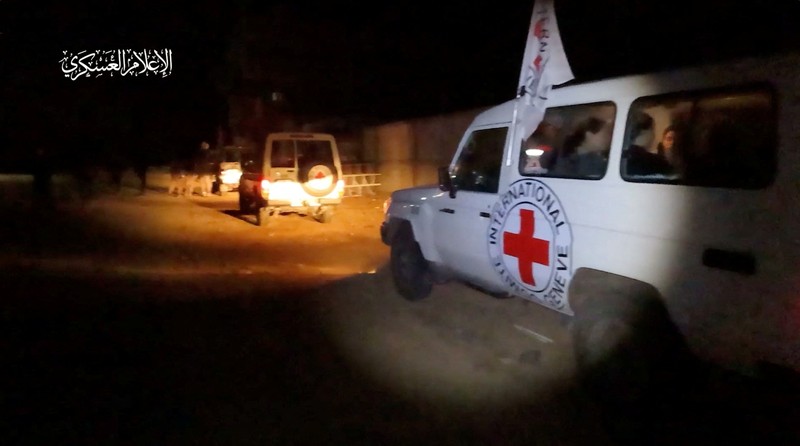 ISRAEL-PALESTINIANS/HOSTAGES Hostages who were abducted by Hamas gunmen during the October 7 attack on Israel, are handed over by Hamas militants to members of the International Committee of the Red Cross, as part of a hostages-prisoners swap deal between Hamas and Israel amid a temporary truce, in an unknown location in the Gaza Strip, in this screengrab taken from video released November 26, 2023. Hamas Military Wing/Handout via REUTERS THIS IMAGE HAS BEEN SUPPLIED BY A THIRD PARTY