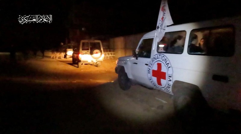 Hostages who were abducted by Hamas gunmen during the October 7 attack on Israel, are handed over by Hamas militants to members of the International Committee of the Red Cross, as part of a hostages-prisoners swap deal between Hamas and Israel amid a temporary truce, in an unknown location in the Gaza Strip, in this screengrab taken from video released November 26, 2023. Hamas Military Wing/Handout via REUTERS THIS IMAGE HAS BEEN SUPPLIED BY A THIRD PARTY