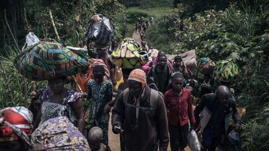Residents of Bambo in Rutshuru territory, 60 kilometers north of Goma, the capital of North Kivu, eastern Democratic Republic of Congo, flee as the M23 attacked the town on October 26, 2023. Around noon, M23 rebels, supported by the Rwandan army according to the UN, the USA and the European Union, attacked the town of Bambo with mortars, causing several thousand inhabitants to flee. Hundreds of Congolese soldiers, police officers and proxy militiamen were seen joining the population as they tried to escape the fighting. Several civilians were killed and wounded in the fighting, according to medical sources on the spot. The M23 has captured swathes of territory in North Kivu province since 2021, forcing more than a million people to flee. (Photo by ALEXIS HUGUET / AFP)