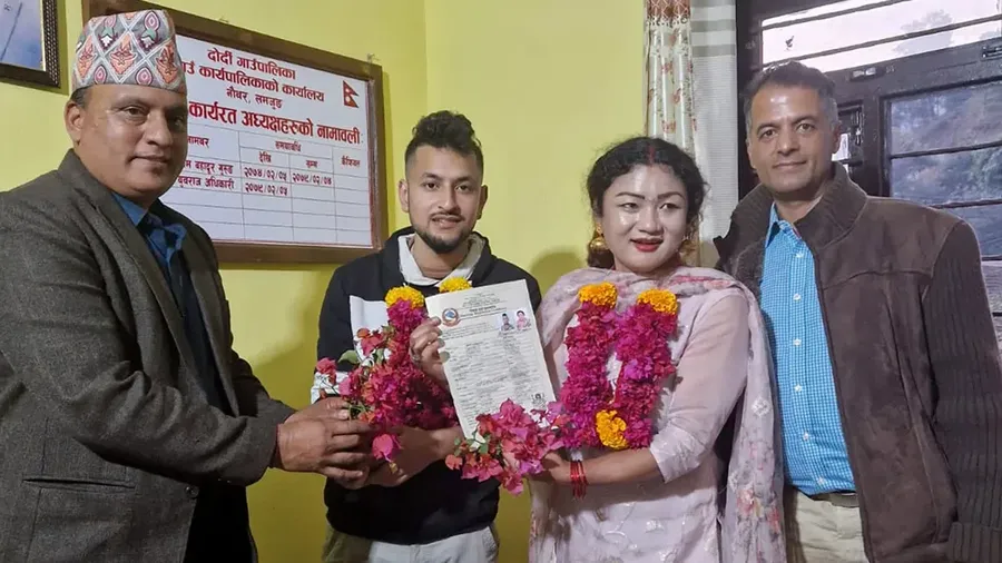 Pasangan sesama jenis Surendra Pandey, kedua dari kiri, dan Maya Gurung berfoto dengan akta nikah di kantor DPRD Dordi, Rabu, 29 November 2023. (Sunil Babu Pant/AP)
