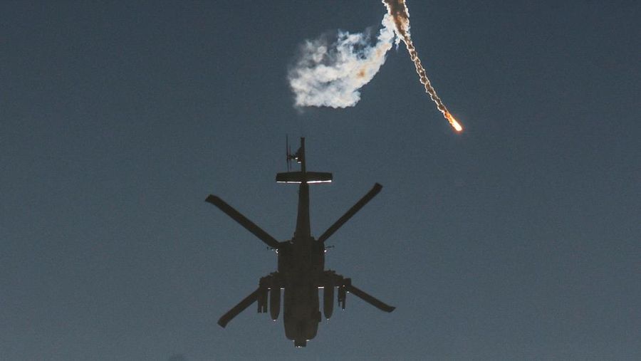 An Israeli military helicopter releases a flare over the Israel-Gaza border, after a temporary truce between Israel and the Palestinian Islamist group Hamas expired, as seen from southern Israel, December 1, 2023. REUTERS/Amir Cohen TPX IMAGES OF THE DAY