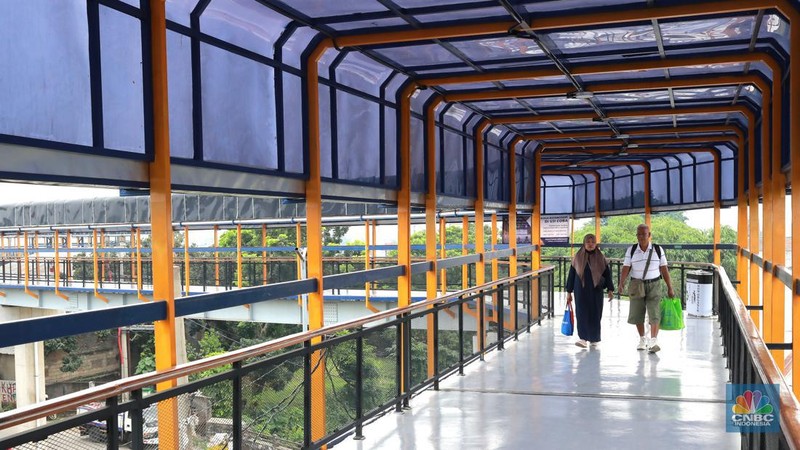 Warga berjalan di area Skybridge Bojonggede di Kabupaten Bogor, Jawa Barat, Rabu, (6/12/2023). Skybridge ini mulai dibuka untuk uji coba 6-7 Desember 2023. Skybridge ini menghubungkan terminal dengan Stasiun Bojonggede. (CNBC Indonesia/Muhammad Sabki)