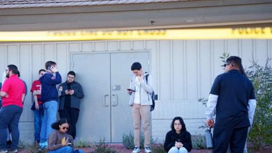 LAS VEGAS, NEVADA - DECEMBER 06: People wait on the outskirts of the UNLV campus after a shooting on December 06, 2023 in Las Vegas, Nevada. According to Las Vegas Metro Police, a suspect is dead and multiple victims are reported after a shooting on the campus. Mingson Lau/Getty Images/AFP (Photo by Mingson Lau / GETTY IMAGES NORTH AMERICA / Getty Images via AFP)