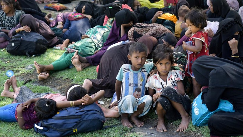 Warga memeriksa perahu kayu yang membawa Muslim Rohingya, setelah mendarat di Blang Ulam, provinsi Aceh, Indonesia, 10 Desember 2023. (REUTERS/Riska Munawarah)     TPX IMAGES OF THE DAY