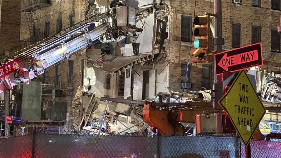 Debris piles up after a building collapsed in the Bronx borough of New York, Monday, Dec. 11, 2023. (AP Photo/Yuki Iwamura)