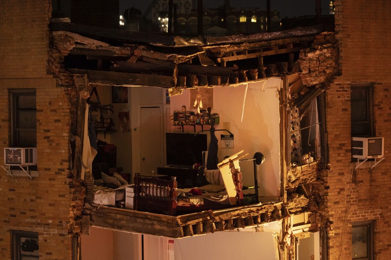 Debris piles up after a building collapsed in the Bronx borough of New York, Monday, Dec. 11, 2023. (AP Photo/Yuki Iwamura)