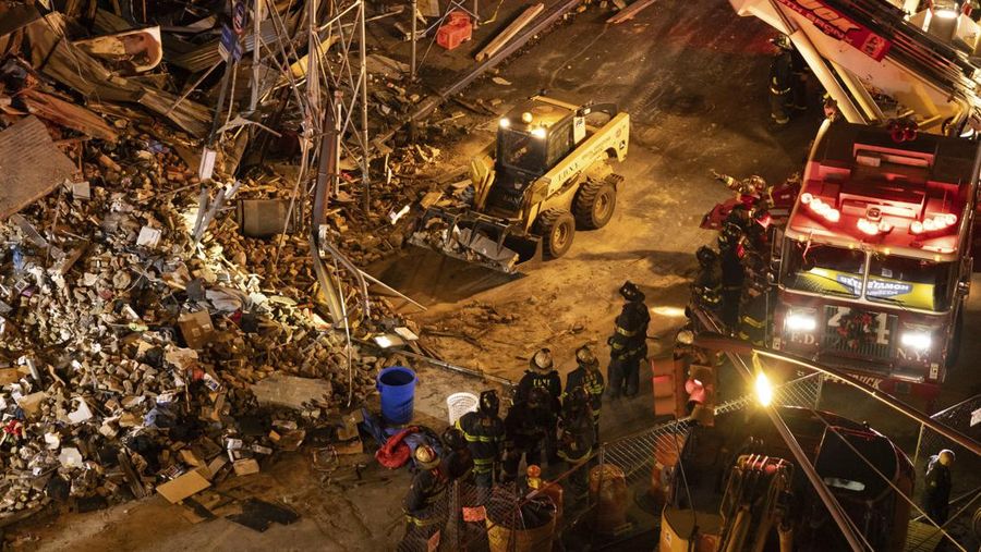 Debris piles up after a building collapsed in the Bronx borough of New York, Monday, Dec. 11, 2023. (AP Photo/Yuki Iwamura)