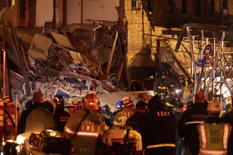Debris piles up after a building collapsed in the Bronx borough of New York, Monday, Dec. 11, 2023. (AP Photo/Yuki Iwamura)