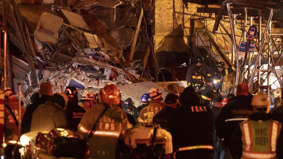 Debris piles up after a building collapsed in the Bronx borough of New York, Monday, Dec. 11, 2023. (AP Photo/Yuki Iwamura)