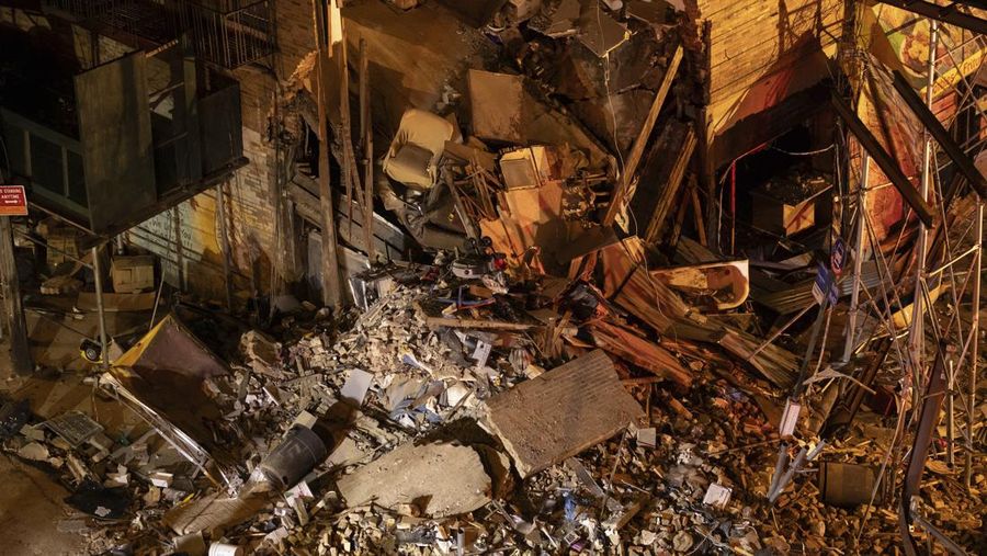 Debris piles up after a building collapsed in the Bronx borough of New York, Monday, Dec. 11, 2023. (AP Photo/Yuki Iwamura)