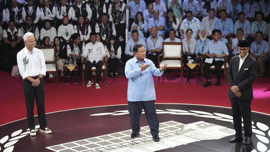 Presidential candidate Prabowo Subianto, center, speaks as other candidates Ganjar Pranowo, left, and Anies Baswedan react during the presidential candidates' debate in Jakarta, Indonesia, Tuesday, Dec. 12, 2023. (AP Photo/Tatan Syuflana)