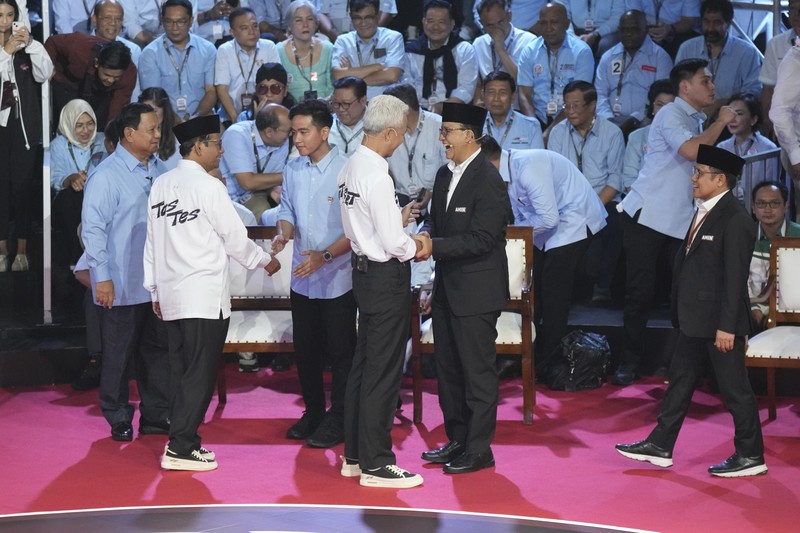 Indonesia Election Presidential candidate Prabowo Subianto, center, speaks as other candidates Ganjar Pranowo, left, and Anies Baswedan react during the presidential candidates' debate in Jakarta, Indonesia, Tuesday, Dec. 12, 2023. (AP Photo/Tatan Syuflana)