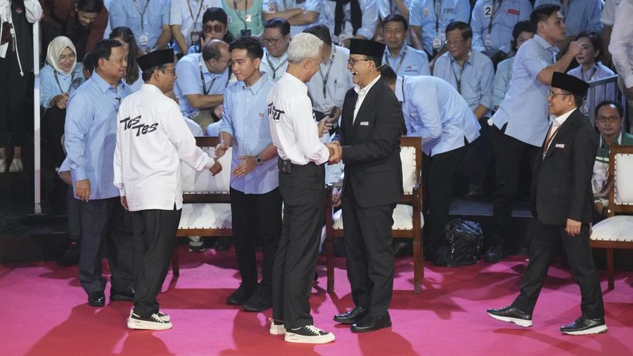 Presidential candidate Prabowo Subianto, center, speaks as other candidates Ganjar Pranowo, left, and Anies Baswedan react during the presidential candidates' debate in Jakarta, Indonesia, Tuesday, Dec. 12, 2023. (AP Photo/Tatan Syuflana)