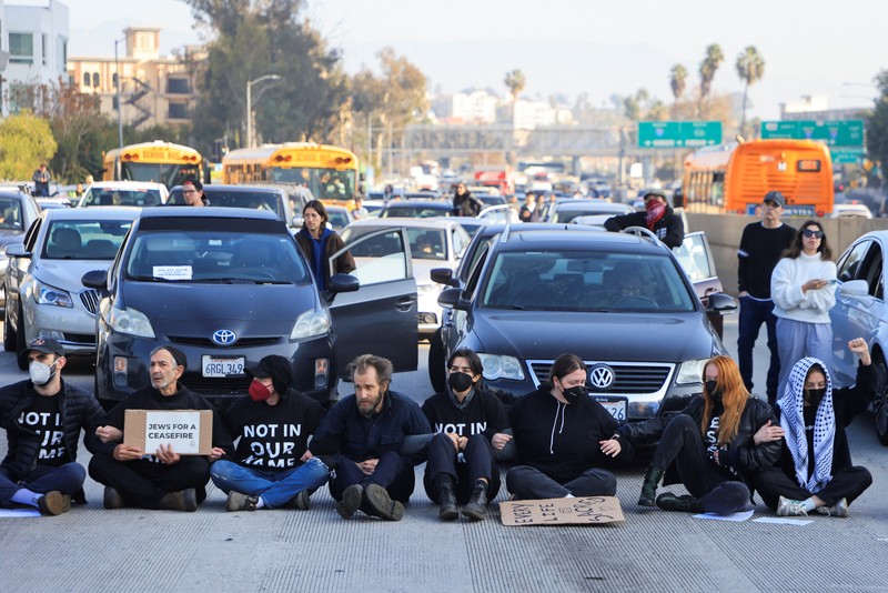 Protesters demanding a ceasefire and an end to U.S. support for Israel's attack on Gaza block morning traffic on the 110 Freeway, in Los Angeles, California, U.S., December 13, 2023. REUTERS/David Swanson