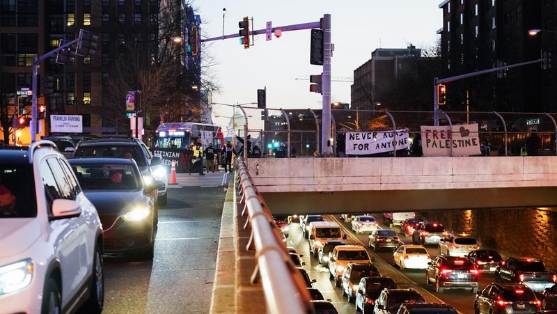 Protestors calling for a ceasefire in the Israel-Hamas war block traffic on New York Avenue NW in Washington, Thursday, Dec. 14, 2023. (AP Photo/Stephanie Scarbrough)