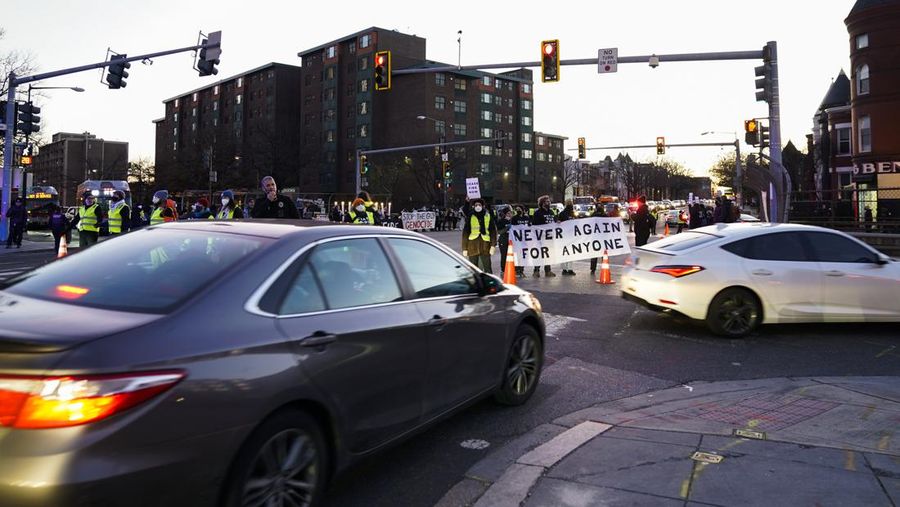 Protestors calling for a ceasefire in the Israel-Hamas war block traffic on New York Avenue NW in Washington, Thursday, Dec. 14, 2023. (AP Photo/Stephanie Scarbrough)