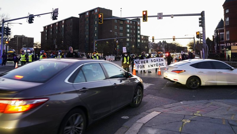 Protestors calling for a ceasefire in the Israel-Hamas war block traffic on New York Avenue NW in Washington, Thursday, Dec. 14, 2023. (AP Photo/Stephanie Scarbrough)