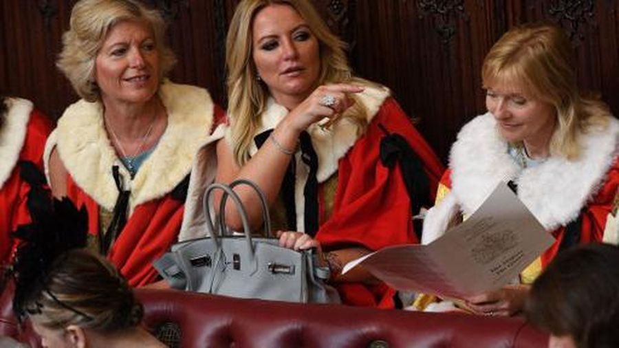 Baroness Michelle Mone (C) waits for the start of the State Opening of Parliament in the Houses of Parliament in London on June 21, 2017. Queen Elizabeth II will formally open parliament and announce the British government's legislative programme on Wednesday, two days later than planned. The state opening, a ceremony full of pomp in which the monarch reads out the Queen's Speech detailing the government's programme for the coming year, was due to take place on June 19, but was delayed after Britain's Prime Minister Theresa May's Conservative party lost their majority in the House of Commons in the June 8 election. (Photo by Stefan Rousseau / POOL / AFP)