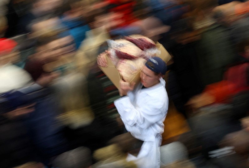 A butcher gathers meat cuts before a a pre-Christmas meat auction held by G Lawrence butchers at Smithfield Market in London, Britain, December 23, 2023. REUTERS/Toby Melville