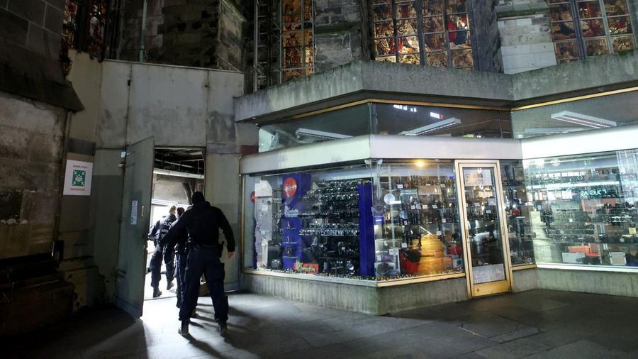 German police walk in front of the cathedral in central Cologne, Germany, December 23, 2023.     REUTERS/Thilo Schmuelgen