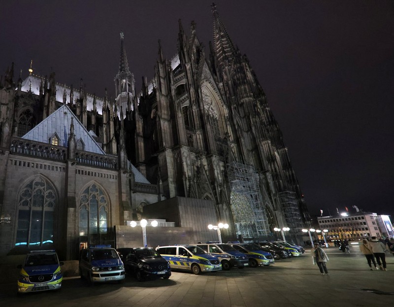 German police walk in front of the cathedral in central Cologne, Germany, December 23, 2023.     REUTERS/Thilo Schmuelgen