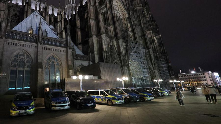German police walk in front of the cathedral in central Cologne, Germany, December 23, 2023.     REUTERS/Thilo Schmuelgen