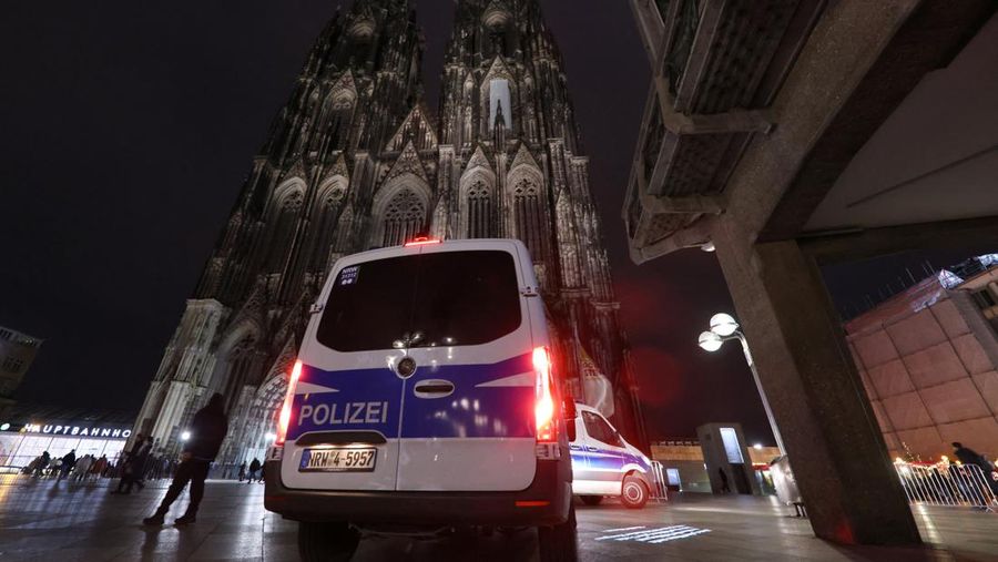 German police walk in front of the cathedral in central Cologne, Germany, December 23, 2023.     REUTERS/Thilo Schmuelgen