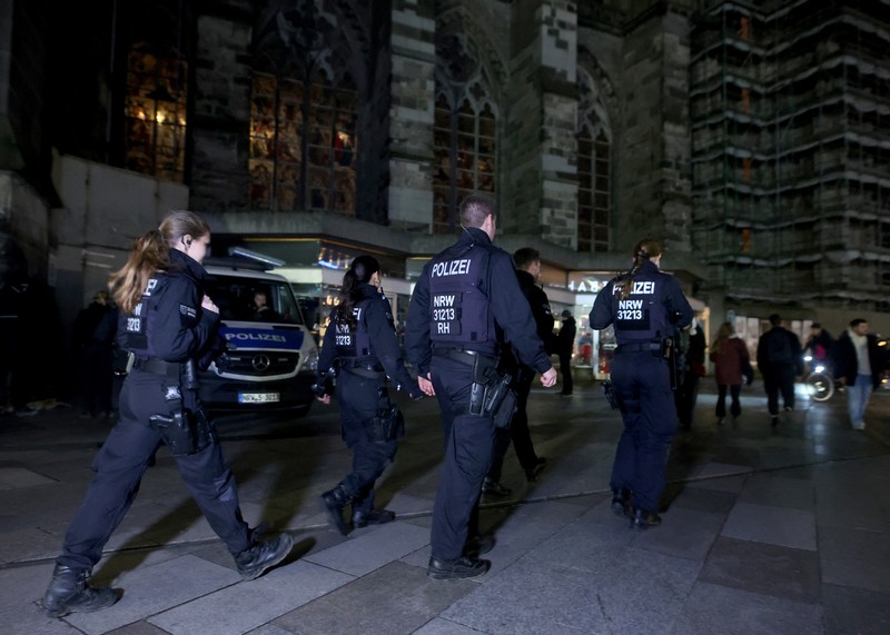 German police walk in front of the cathedral in central Cologne, Germany, December 23, 2023.     REUTERS/Thilo Schmuelgen